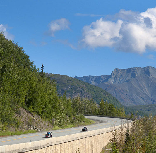 A pair of motorcycles hauling fifth wheels show another approach to motorcycle adventuring.