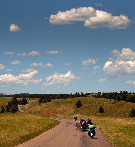 Motorcyclists enjoy a sunny cruise during the Sturgis Motorcycle Rally photo