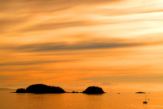Early mornings on the ferry from Port Hardy to Prince Rupert, British Columbia provide superb silhouettes of Inland Passage islands against fiery orange skies.