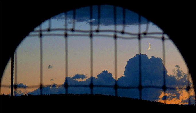 Seen from the Full Throttle Saloon, the moon rises above Sturgis, South Dakota, home to the world's largest motorcycle rally since 1938.