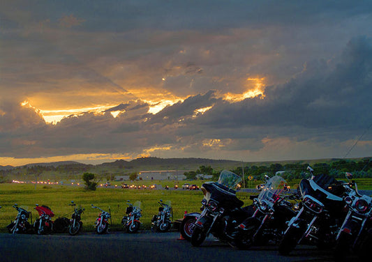 As the sun sets on another day of riding at the Sturgis Motorcycle Rally in South Dakota, the owners of this lineup of Harley-Davidson motorcycles quench their thirst at the Full Throttle Saloon.