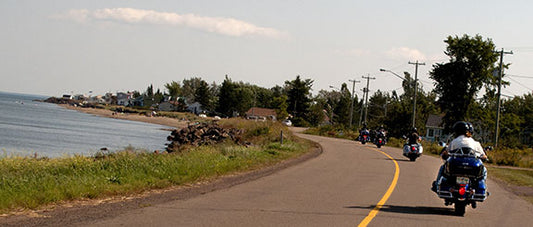 Motorcyclists cruise along the coast of New Brunswick, Canada 