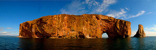 The reddish-gold limestone and shale of Perce Rock on the Gaspe Peninsula in Quebec provides stunning color in the afternoon sun.