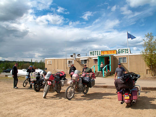 A group of motorcycle adventurers, mostly off-road bike riders, gathers at the first service station on Alaska’s Dalton Highway as they make their way to the Arctic Circle