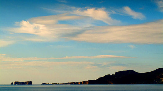 Perce Rock extends off the coast of the Gaspe Peninsula into the Gulf of Saint Lawrence in Quebec, Canada.