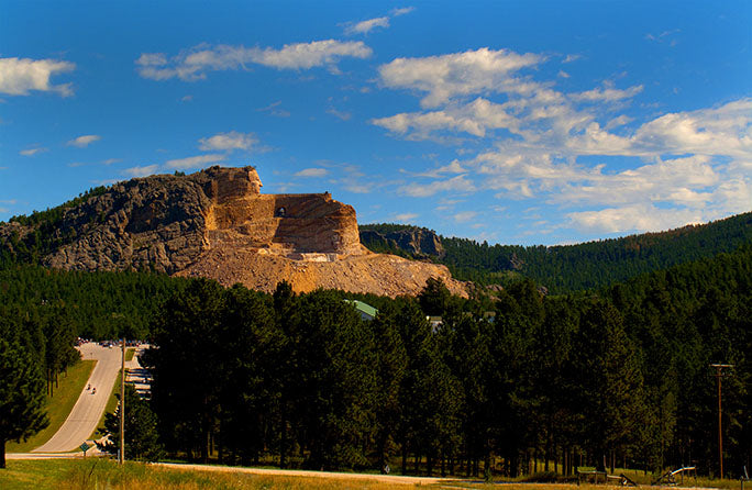 While on his cross-country motorcycle adventure, photographer Geoffrey Kula stopped by the Crazy Horse Memorial in South Dakota's Black Hills and shot this image of two motorcyclists leaving Thunderhead Mountain.